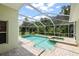 Enjoy this lovely backyard oasis, featuring a screened-in pool and spa, perfect for relaxation at 4948 Ridgemoor Cir, Palm Harbor, FL 34685