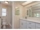 Bathroom features a white vanity, dual mirrors, and a shower with glass doors at 5008 Glenn Dr, New Port Richey, FL 34652