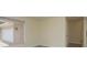 Bright bedroom with a large window overlooking the front driveway at 5008 Glenn Dr, New Port Richey, FL 34652
