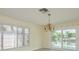 Bright dining room with decorative chandelier and sliding glass doors to the patio at 5008 Glenn Dr, New Port Richey, FL 34652