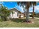 Exterior shot features a well-manicured lawn, and a stucco home with a stone facade at 5008 Glenn Dr, New Port Richey, FL 34652