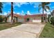 Charming single-story home showcasing a well-maintained lawn and a two-car attached garage at 5008 Glenn Dr, New Port Richey, FL 34652