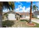 Single-story home featuring stone accents, a red tile roof, a well-kept lawn, and lush landscaping at 5008 Glenn Dr, New Port Richey, FL 34652