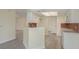 Cozy kitchen featuring white cabinets and modern tile flooring at 5008 Glenn Dr, New Port Richey, FL 34652