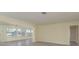 Bright and airy living room featuring wood-look floors and large windows with backyard views at 5008 Glenn Dr, New Port Richey, FL 34652