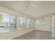 Sunroom filled with natural light from the many windows overlooking the water at 5008 Glenn Dr, New Port Richey, FL 34652