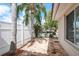Brick patio area features canal views through a white fence, with palm trees adding to the tropical feel at 5008 Glenn Dr, New Port Richey, FL 34652