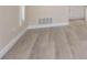 Neutral room features gray floors, white baseboards, and a window with white trim at 5008 Glenn Dr, New Port Richey, FL 34652