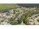 Aerial view of a community nestled among lush greenery and serene water features at 5360 Karlsburg Pl, Palm Harbor, FL 34685