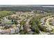 Aerial view of a residential area surrounded by lush green trees and lakes at 5360 Karlsburg Pl, Palm Harbor, FL 34685