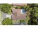 Aerial view of a house with an enclosed pool surrounded by trees at 5360 Karlsburg Pl, Palm Harbor, FL 34685