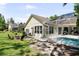 Charming home with a screened-in pool and a cozy fire pit in the backyard at 5360 Karlsburg Pl, Palm Harbor, FL 34685