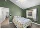 Green bedroom featuring natural light, providing a warm and inviting feel, with views into a study at 5360 Karlsburg Pl, Palm Harbor, FL 34685