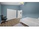 Bedroom featuring blue walls, wood floors, a closet, and natural light with a ceiling fan at 5360 Karlsburg Pl, Palm Harbor, FL 34685