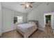 Well-lit bedroom features wood floors, a window, and a neutral color scheme, offering a calming space at 5360 Karlsburg Pl, Palm Harbor, FL 34685