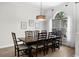 Dining room featuring hardwood floors, large window, and chandelier at 5360 Karlsburg Pl, Palm Harbor, FL 34685