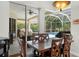 Dining room with wood table set and view of screened-in patio and pool at 5360 Karlsburg Pl, Palm Harbor, FL 34685