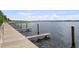 Scenic view of a wooden dock extending into calm water, ideal for boating and waterside activities at 5360 Karlsburg Pl, Palm Harbor, FL 34685