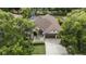 Beautiful aerial view of home with lush landscaping and large driveway at 5360 Karlsburg Pl, Palm Harbor, FL 34685