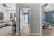 Hallway view showing doorways to bedrooms and a bathroom, providing a glimpse of the home's layout at 5360 Karlsburg Pl, Palm Harbor, FL 34685