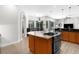 Open-concept kitchen with gas cooktop and eat-in area; view of the living room and dining room at 5360 Karlsburg Pl, Palm Harbor, FL 34685
