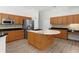 Spacious kitchen with center island, stainless appliances, and wood cabinets at 5360 Karlsburg Pl, Palm Harbor, FL 34685