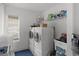 Bright laundry room with modern washer and dryer and ample storage at 5360 Karlsburg Pl, Palm Harbor, FL 34685
