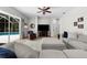 Bright living room with sectional sofa, leather chair, and view of the pool at 5360 Karlsburg Pl, Palm Harbor, FL 34685
