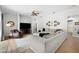 Spacious living room with sectional sofa, wood floors, ceiling fan, and decor at 5360 Karlsburg Pl, Palm Harbor, FL 34685