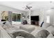 Comfortable living room featuring a large sectional sofa and view of the backyard pool at 5360 Karlsburg Pl, Palm Harbor, FL 34685