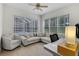 Bright living room with ample seating, a desk area, and large windows for plenty of natural light at 5360 Karlsburg Pl, Palm Harbor, FL 34685