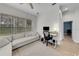 Bright living room and desk area feature a large window and a comfortable sofa, ideal for relaxing and working at 5360 Karlsburg Pl, Palm Harbor, FL 34685