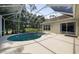 Landscaped backyard with a screened pool, offering a private and tranquil outdoor space at 5360 Karlsburg Pl, Palm Harbor, FL 34685