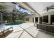 Spacious screened-in pool and patio area, perfect for outdoor entertaining and relaxation at 5360 Karlsburg Pl, Palm Harbor, FL 34685
