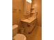 Standard vanity with cabinets for storage with toilet and paper towel holder in shot at 5623 80Th N St # 314, St Petersburg, FL 33709