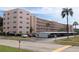 Condo building with a parking lot and tropical landscaping, under a partly cloudy sky at 5623 80Th N St # 314, St Petersburg, FL 33709