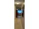 Inviting hallway view with tile floors, a decorative mirror, and a glimpse of the living area at 5623 80Th N St # 314, St Petersburg, FL 33709