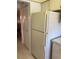 Functional kitchen view featuring a white refrigerator and access to other areas at 5623 80Th N St # 314, St Petersburg, FL 33709
