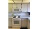 Well-equipped kitchen showcasing white appliances, including a gas range and microwave at 5623 80Th N St # 314, St Petersburg, FL 33709