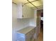 A bright view of the kitchen with counter space, hanging cabinets and dining room doorway at 5623 80Th N St # 314, St Petersburg, FL 33709