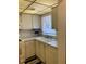 Bright kitchen area with a double sink, tiled backsplash, and white cabinetry at 5623 80Th N St # 314, St Petersburg, FL 33709