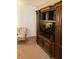 Living room featuring an entertainment center with a large TV, speakers, and display cabinets at 5623 80Th N St # 314, St Petersburg, FL 33709