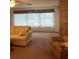 Spacious living room featuring a ceiling fan and large window for lots of natural light at 5623 80Th N St # 314, St Petersburg, FL 33709
