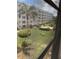 Window view showcases the well-maintained community landscaping and building exterior at 5623 80Th N St # 314, St Petersburg, FL 33709