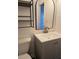 Bathroom with a gray vanity, black framed mirror, and modern sink faucet at 5925 Terrace Park N Dr # 210, St Petersburg, FL 33709