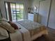 Bright bedroom showcasing a comfortable bed and access to an outdoor patio at 5925 Terrace Park N Dr # 210, St Petersburg, FL 33709