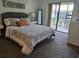 Inviting bedroom features a comfortable bed and sliding doors to a patio at 5925 Terrace Park N Dr # 210, St Petersburg, FL 33709