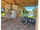 Outdoor picnic area with tables, grill, and view of the pond at 5925 Terrace Park N Dr # 210, St Petersburg, FL 33709