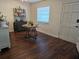 Airy dining room featuring dark flooring, modern furnishings, and natural light from the window at 5925 Terrace Park N Dr # 210, St Petersburg, FL 33709