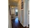 Hallway with dark wood floors and a view into the bedroom at 5925 Terrace Park N Dr # 210, St Petersburg, FL 33709